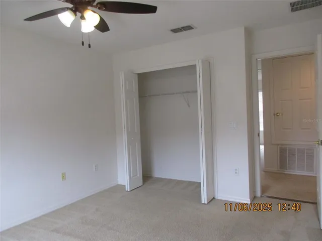 an empty room with a chandelier fan