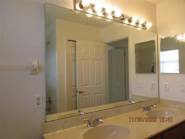 a bathroom with a sink and mirror