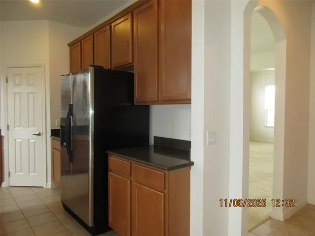 a kitchen with a refrigerator and cabinets