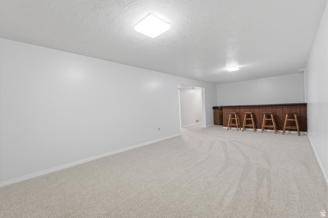 148 Tennyson Avenue Sandy, UT 84070 - Photo 31 of 55 Spacious room featuring light-colored carpeting, white painted walls, and square ceiling light fixtures