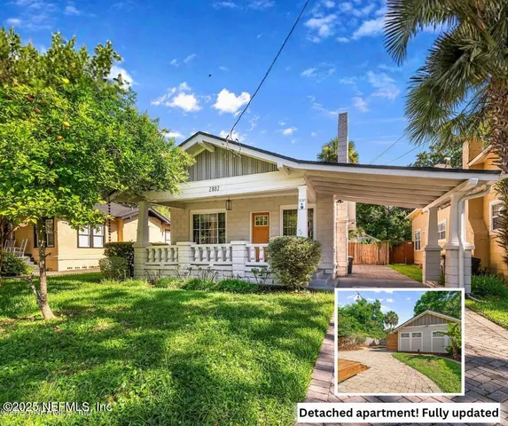 a front view of house with yard and green space