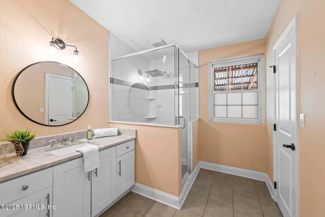 a bathroom with a granite countertop sink mirror and vanity