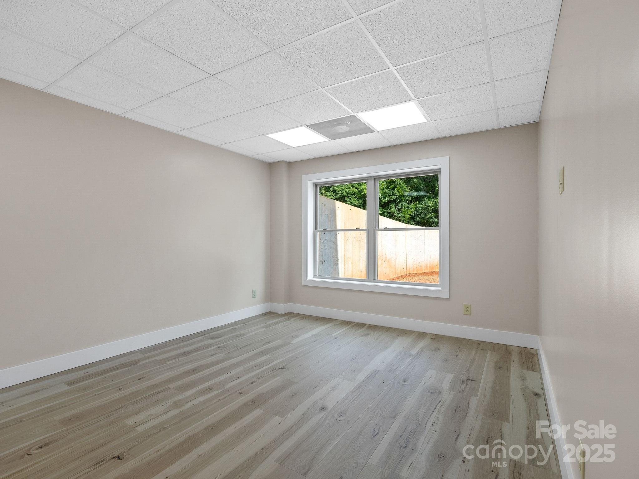 185 Robinson Acres Cove Lane Rutherfordton, NC 28139 - Photo 21 of 37 an empty room with wooden floor and windows