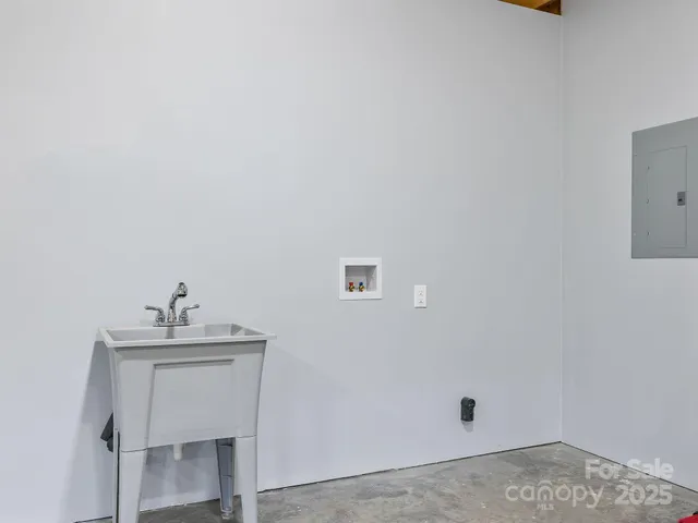 a view of a livingroom with a flat screen tv and a window