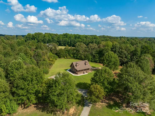 an aerial view of a residential houses with outdoor space