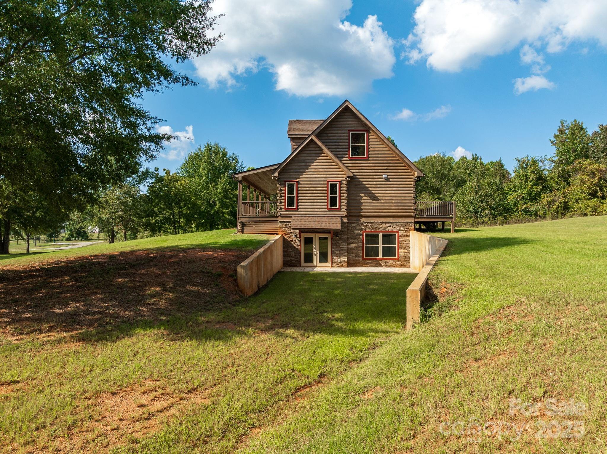 185 Robinson Acres Cove Lane Rutherfordton, NC 28139 - Photo 6 of 37 a front view of a house with yard and green space
