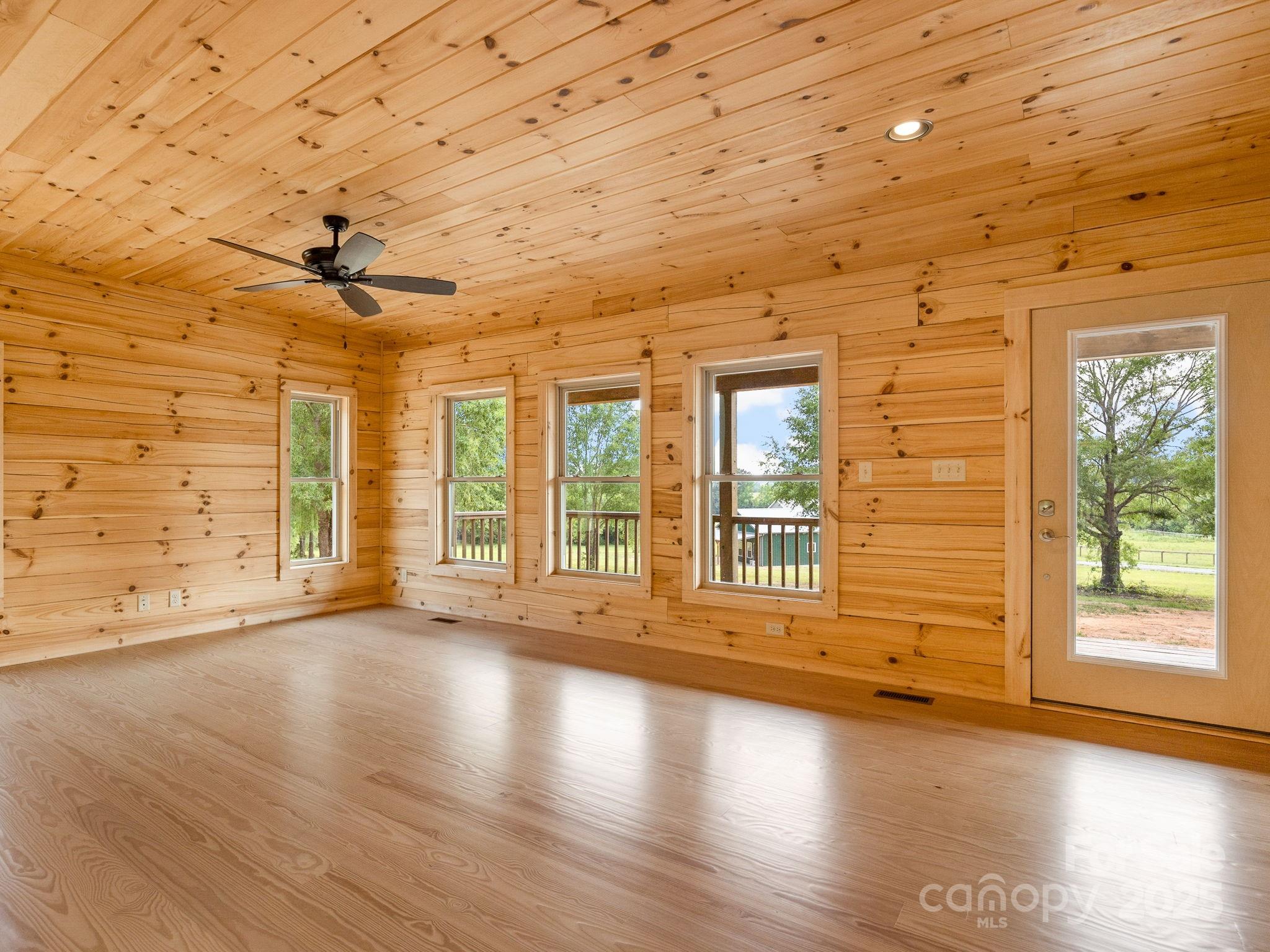 185 Robinson Acres Cove Lane Rutherfordton, NC 28139 - Photo 7 of 37 a view of empty room with wooden floor and fan