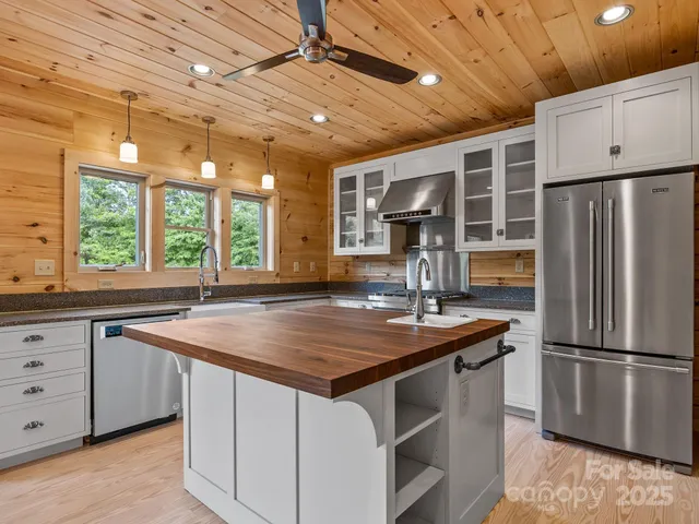 a kitchen with stainless steel appliances a sink stove and refrigerator