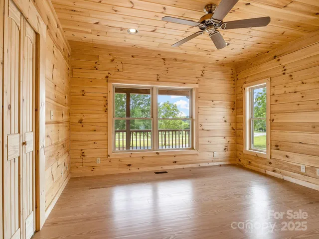 a view of a livingroom with wooden floor and a window