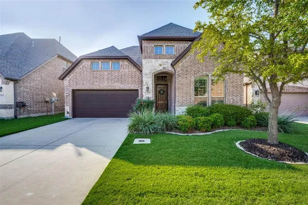 a front view of a house with a yard and garage