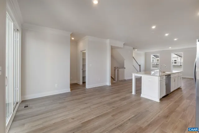 a view of a kitchen with wooden floor and electronic appliances