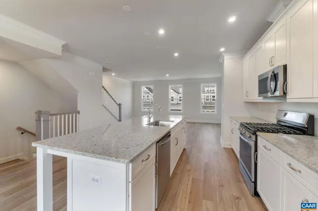 a kitchen with granite countertop a stove and a sink