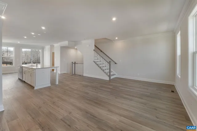a view of a room with a ceiling fan and wooden floor
