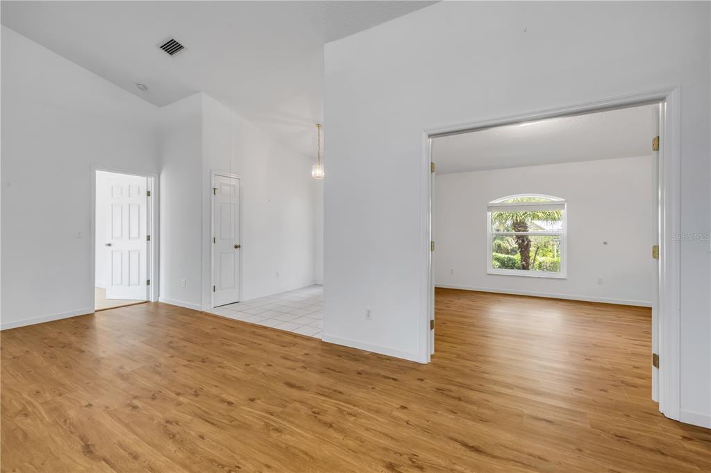 192 Azalea Road Edgewater, FL 32141 - Photo 47 of 94 a view of an empty room with wooden floor and a window
