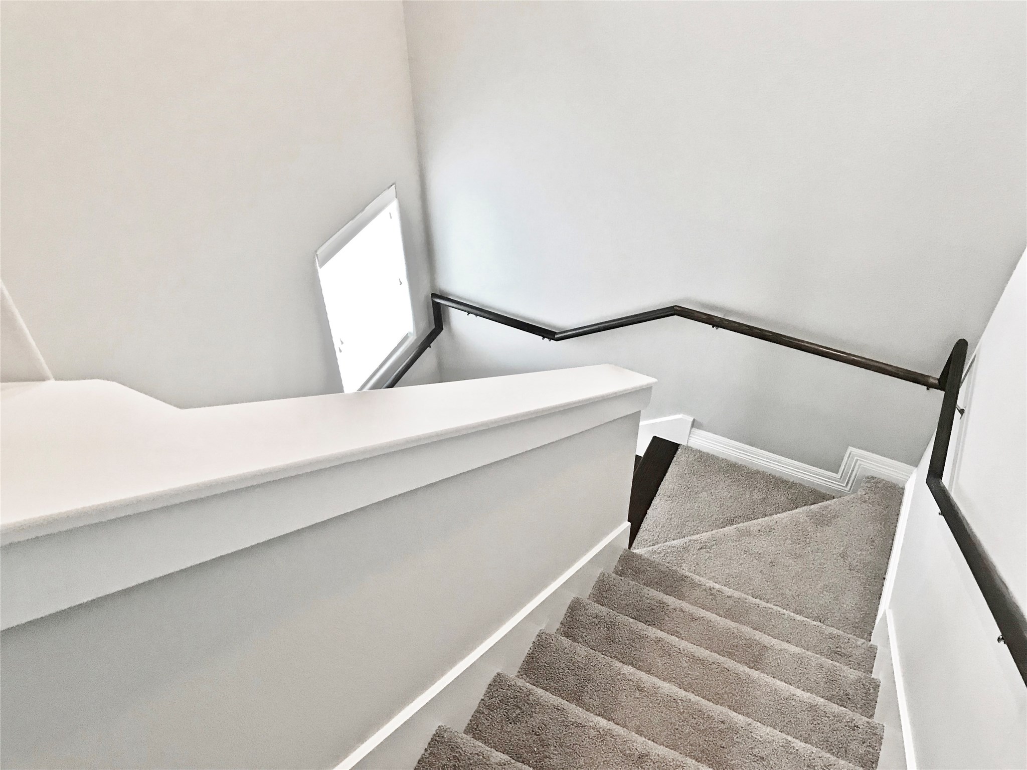 709 Link Road Houston, TX 77009 - Photo 13 of 41 LOOKING DOWN STAIRWELL FROM THIRD FLOOR LANDING, STRATEGICALLY PLACED WINDOWS MAKE THE ASCENT LITE AND BRIGHT