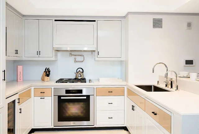 a living room with granite countertop couches a fireplace with wooden floor dining table and chairs