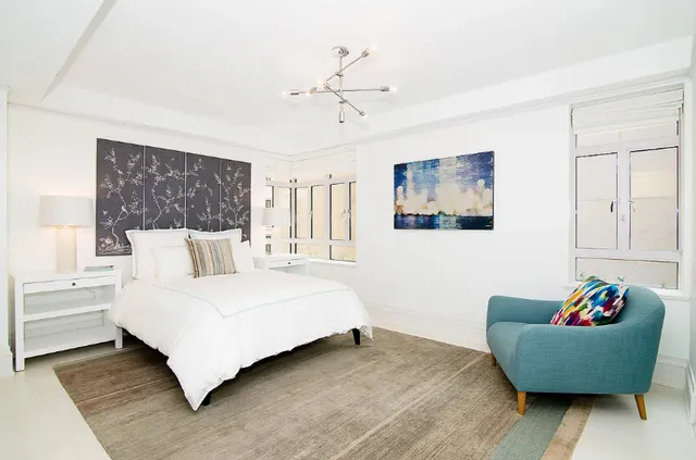 a bedroom with a large bed and a large window