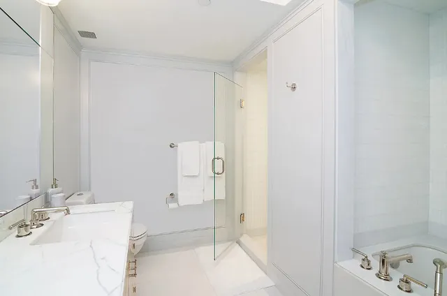 a spacious bathroom with a granite countertop sink mirror and toilet