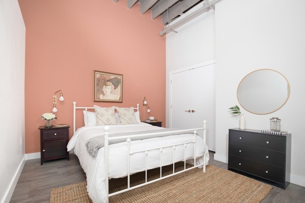 a bedroom with a bed and a mirror