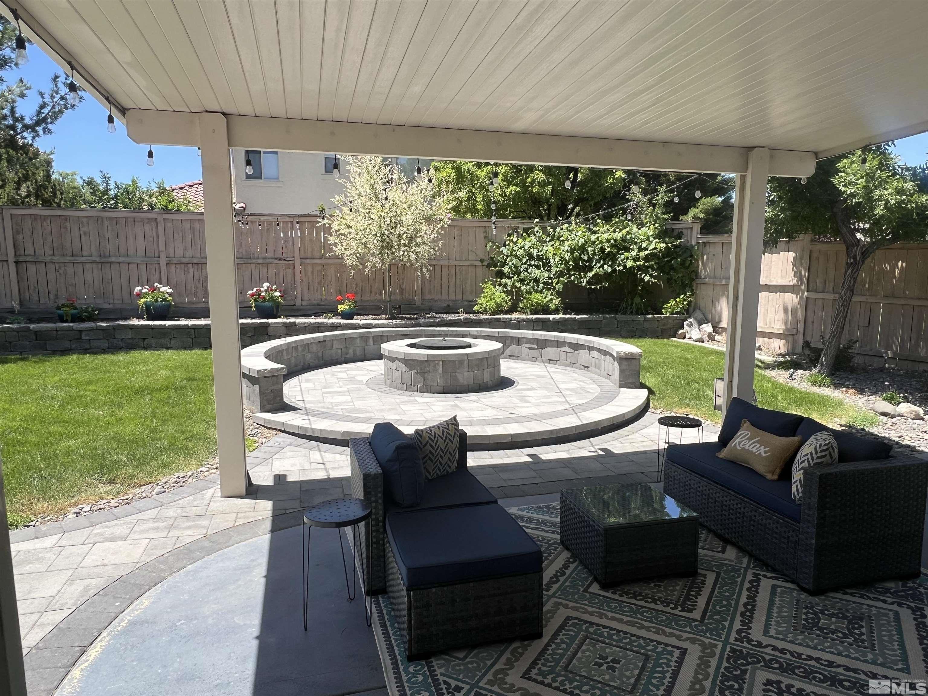 a view of an outdoor dining space with a table and chairs