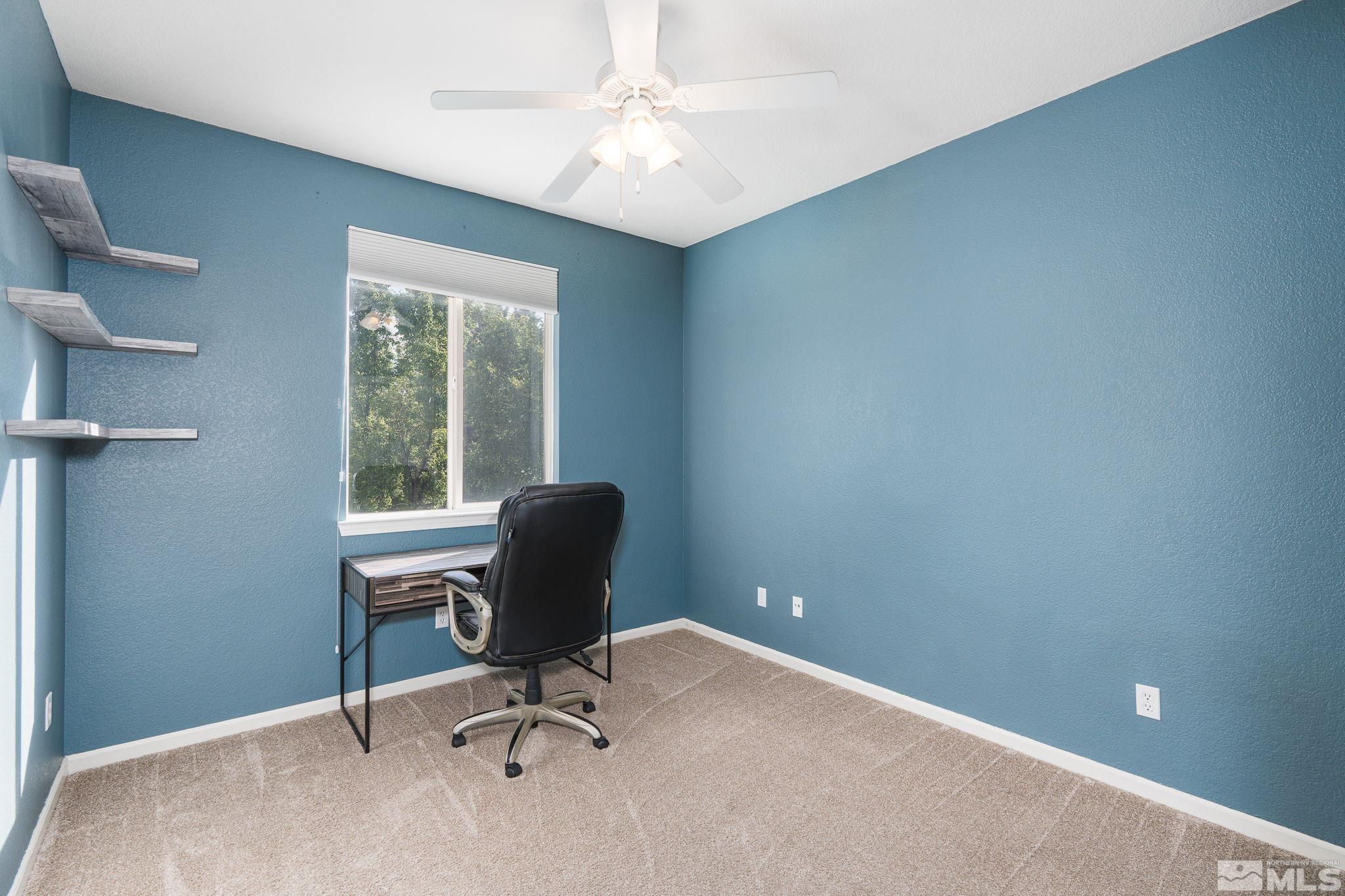 10650 Copper Lake Drive Reno, NV 89521 - Photo 27 of 40 a view of a workspace with furniture and a window