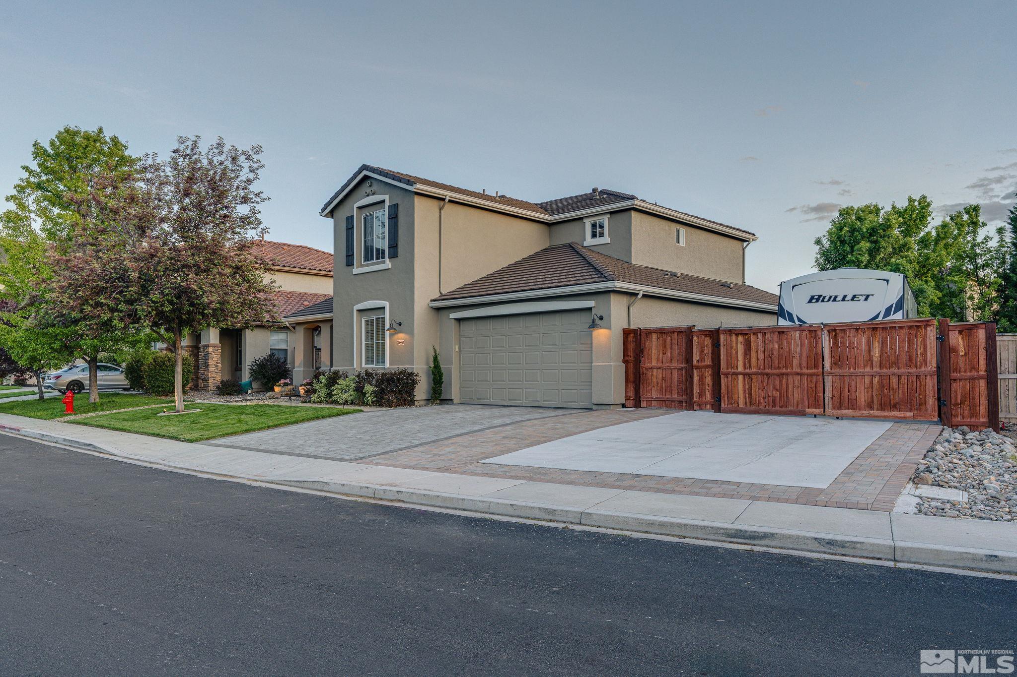 10650 Copper Lake Drive Reno, NV 89521 - Photo 5 of 40 a front view of a house with a yard and garage