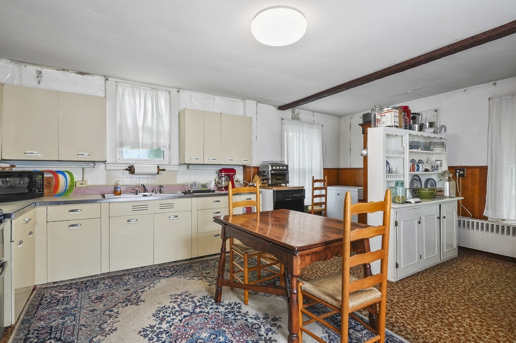 90 Common Street Barre, MA 01005 - Photo 14 of 27 a room with furniture a rug and a kitchen view