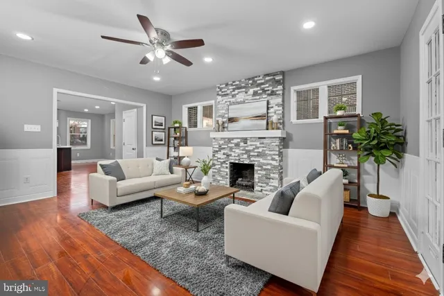a living room with furniture a fireplace and a potted plant