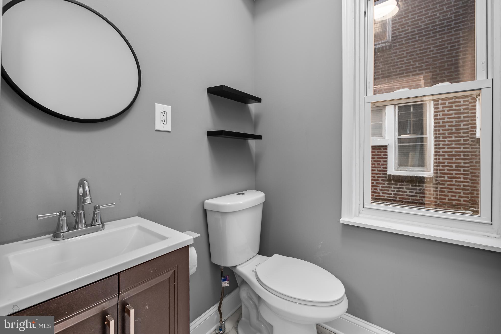 558 East Locust Avenue Philadelphia, PA 19144 - Photo 11 of 33 a bathroom with a toilet a sink and mirror