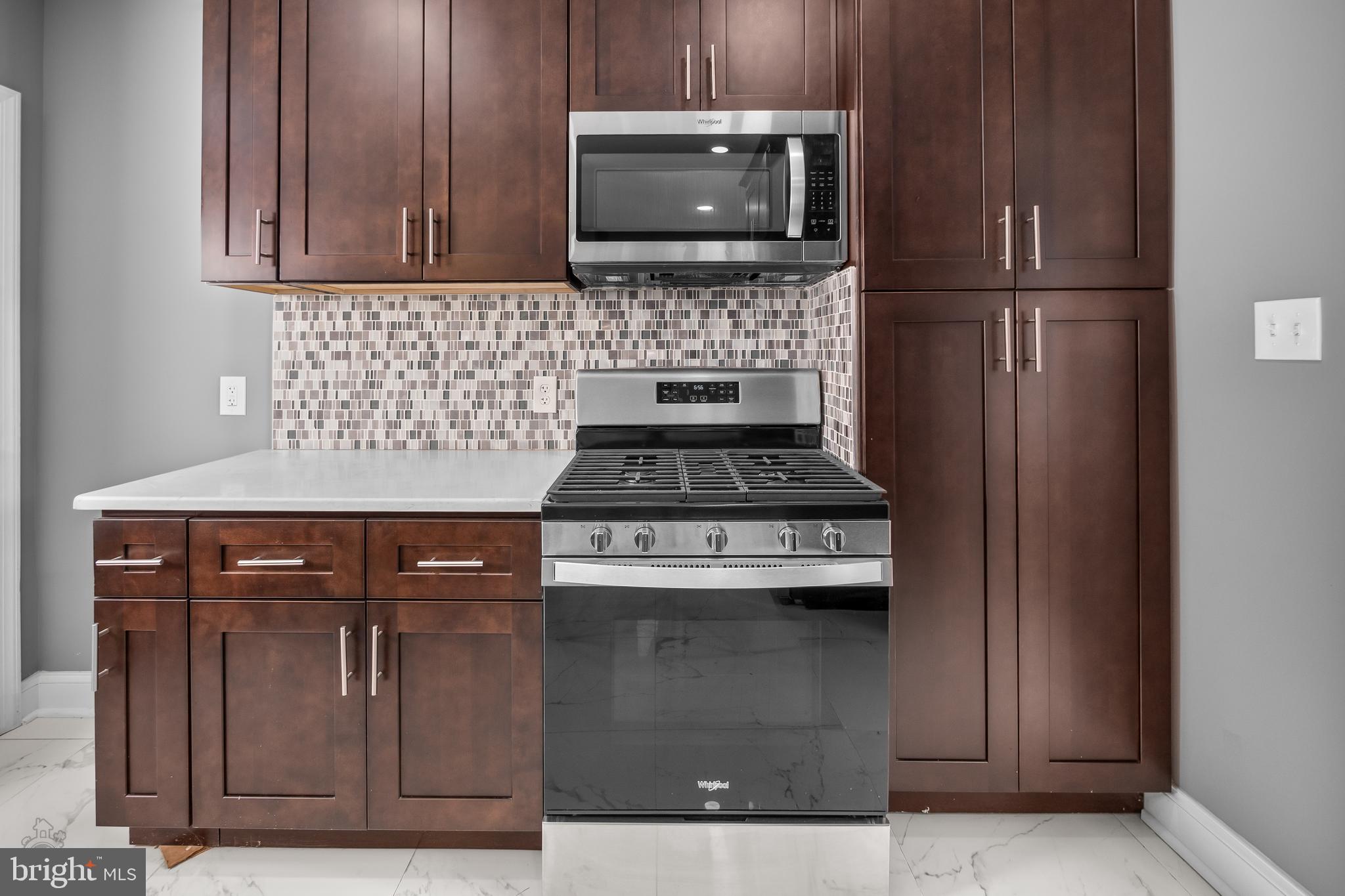 558 East Locust Avenue Philadelphia, PA 19144 - Photo 12 of 33 a kitchen with granite countertop cabinets and steel stainless steel appliances