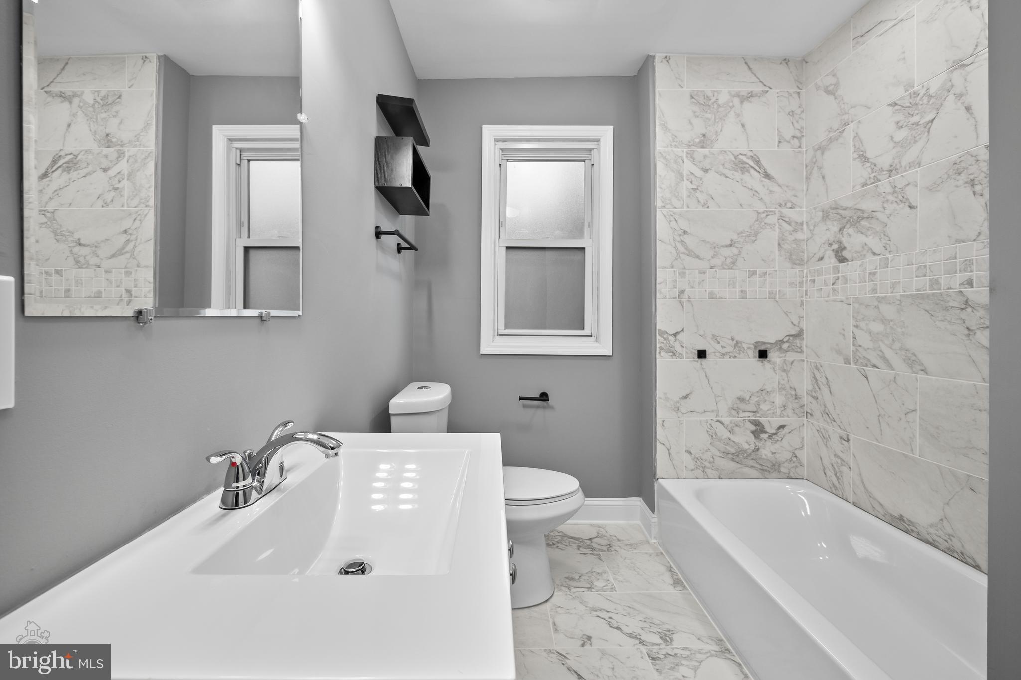 558 East Locust Avenue Philadelphia, PA 19144 - Photo 18 of 33 a bathroom with a sink a toilet and bathtub