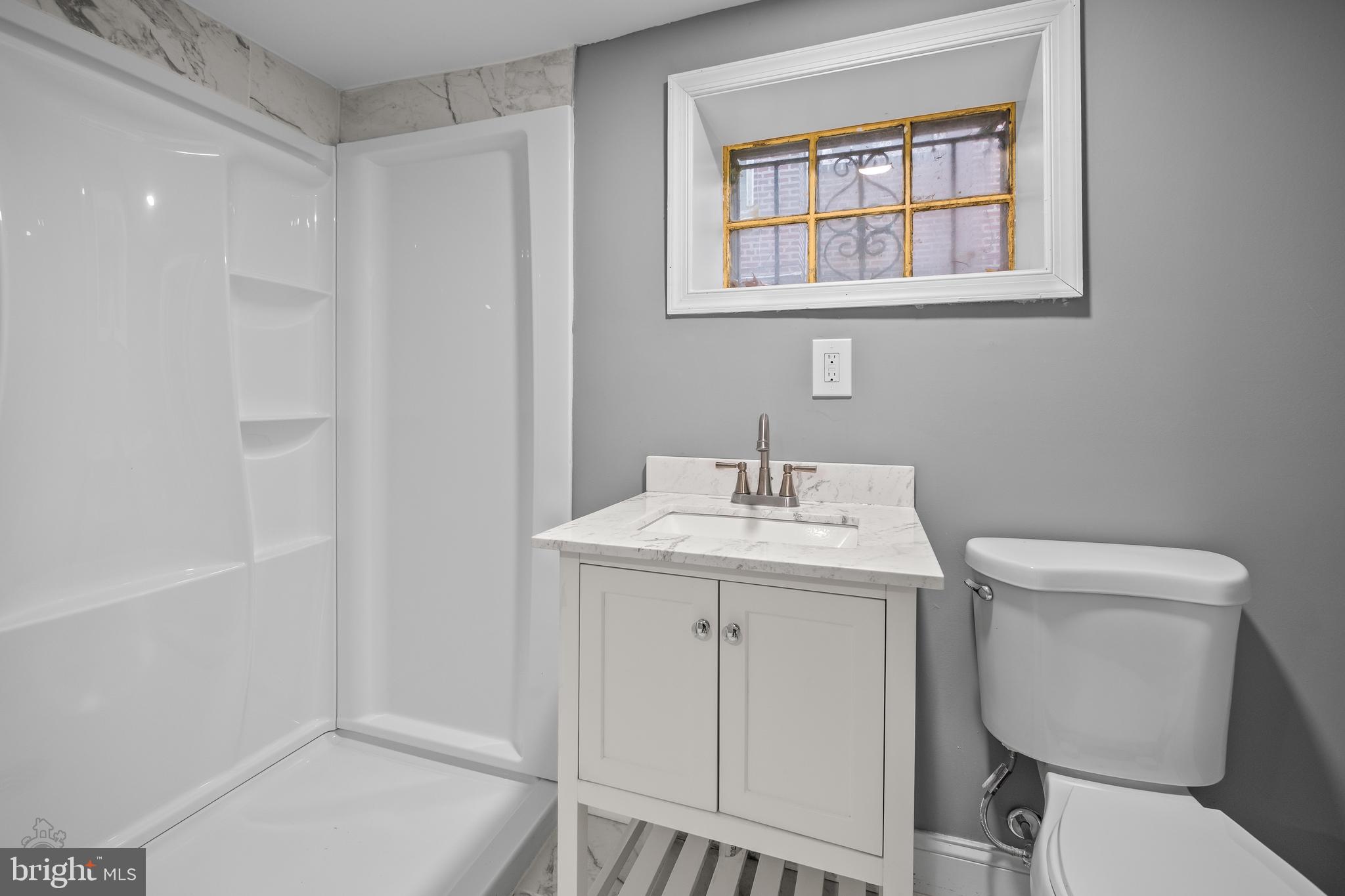 558 East Locust Avenue Philadelphia, PA 19144 - Photo 23 of 33 a bathroom with a toilet a sink and a window