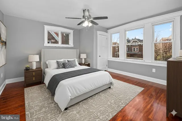 a spacious bedroom with a large bed and a chandelier