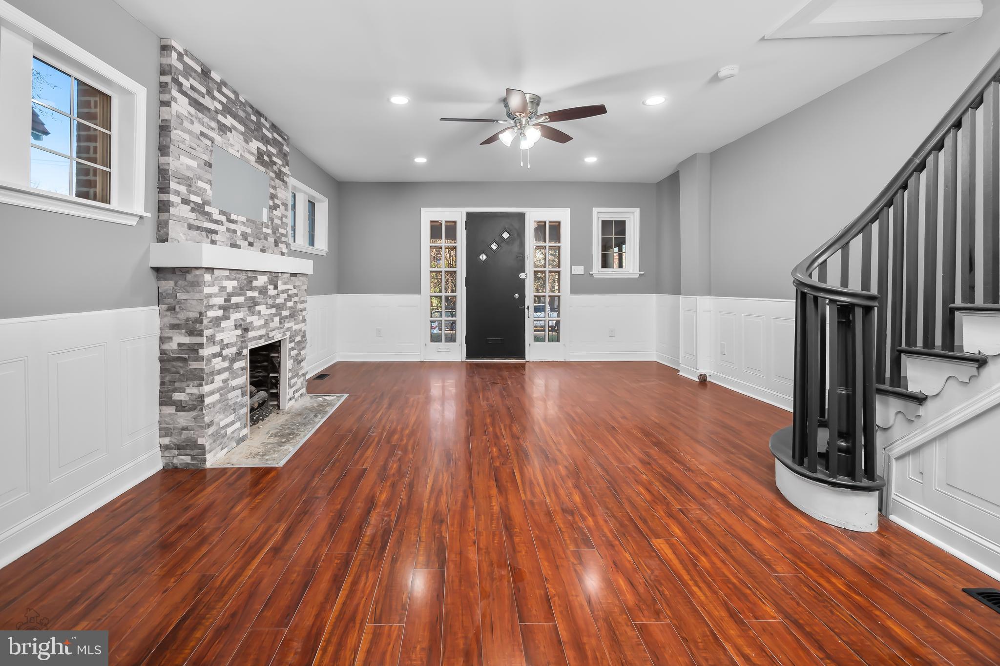 558 East Locust Avenue Philadelphia, PA 19144 - Photo 6 of 33 a view of a livingroom with wooden floor and a ceiling fan