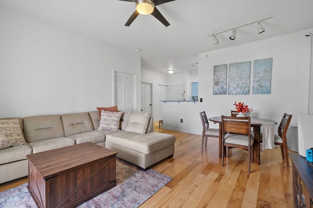21 Hampshire Road, Unit 412 Methuen, MA 01844 - Photo 12 of 17 a living room with furniture and a wooden floor