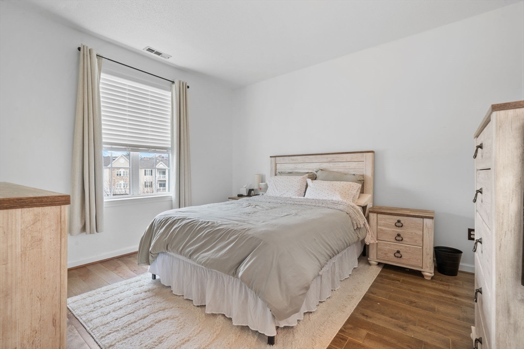 21 Hampshire Road, Unit 412 Methuen, MA 01844 - Photo 15 of 17 a bedroom with a bed and a window