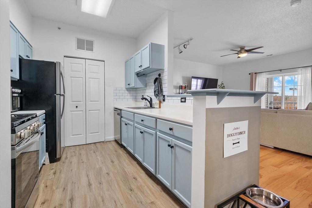 21 Hampshire Road, Unit 412 Methuen, MA 01844 - Photo 7 of 17 a kitchen with cabinets a refrigerator and a stove