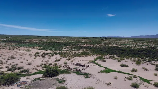 an aerial view of a house with a yard and lake view