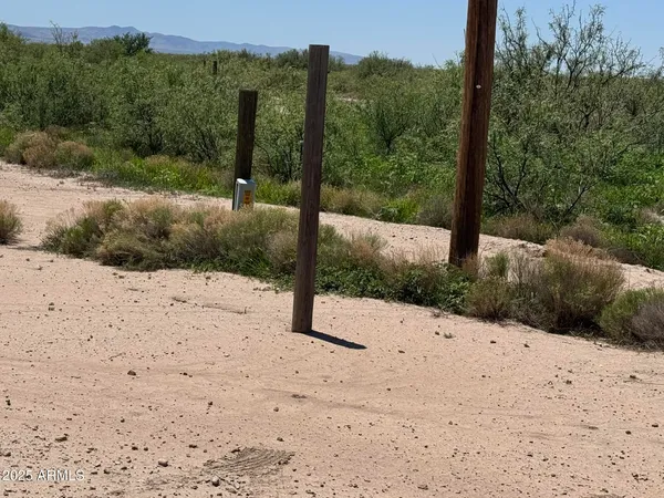 a view of mountain with sunset in background