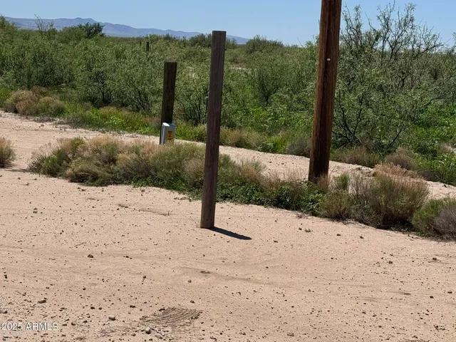a view of mountain with sunset in background