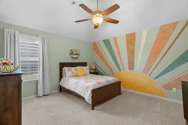 a bedroom with a bed and a chandelier