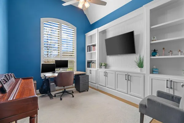 a view of a livingroom with workspace and a window