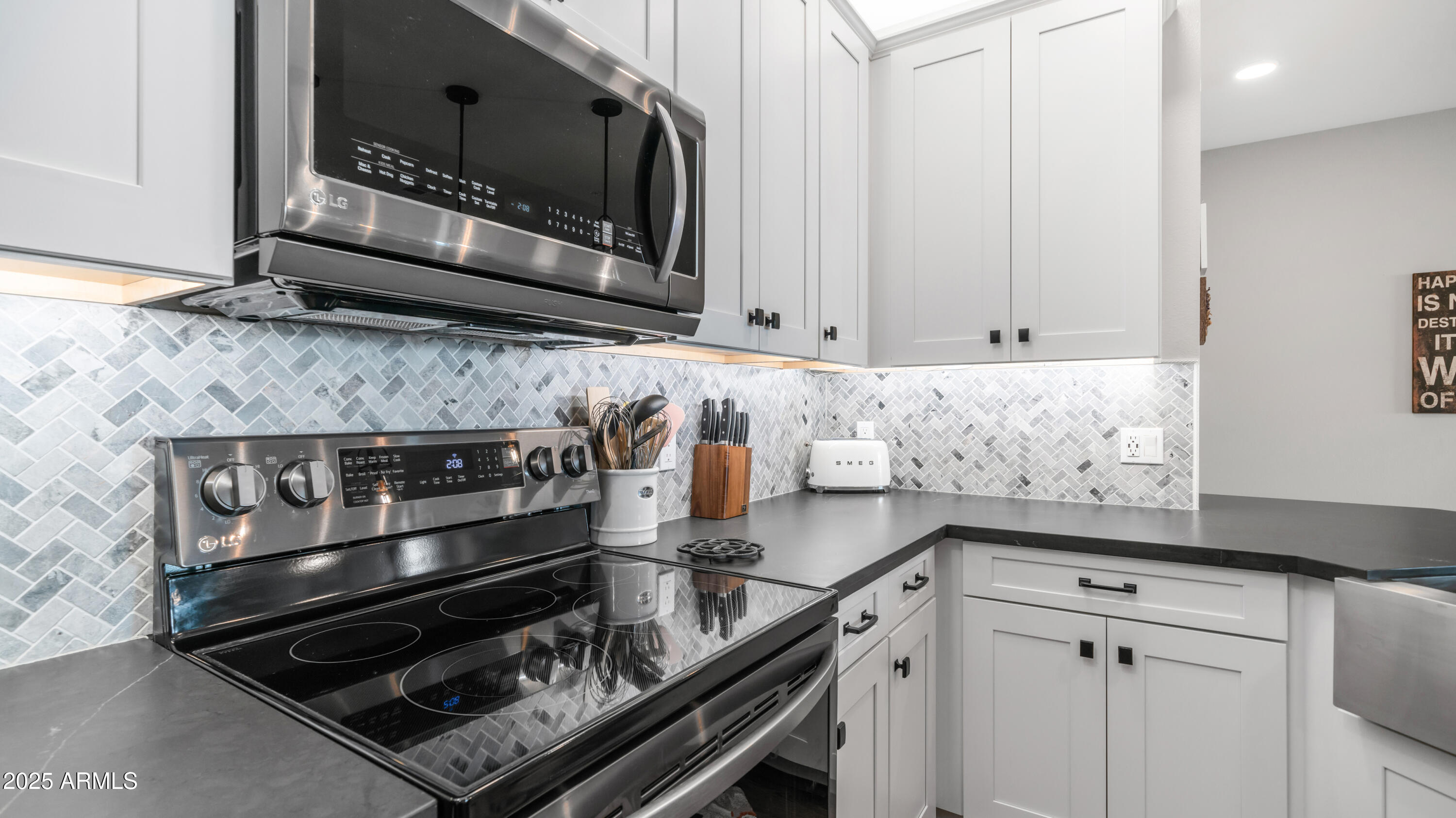 2511 West Queen Creek Road, Unit 166 Chandler, AZ 85248 - Photo 10 of 66 a kitchen with stainless steel appliances granite countertop a stove and a microwave