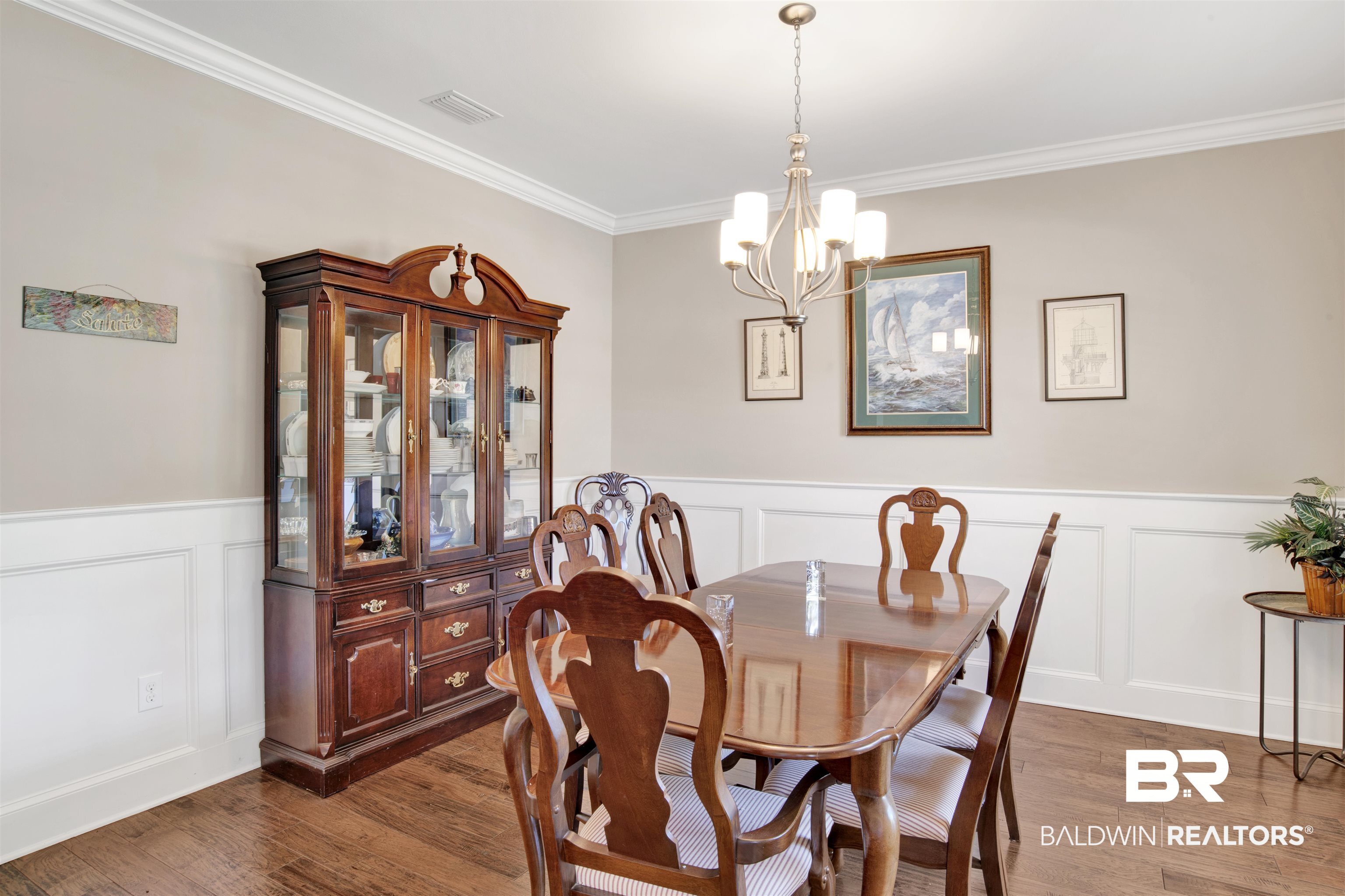 360 Scarlett Avenue Fairhope, AL 36532 - Photo 7 of 34 Dining area with ornamental molding, hardwood / wood-style floors, and a chandelier