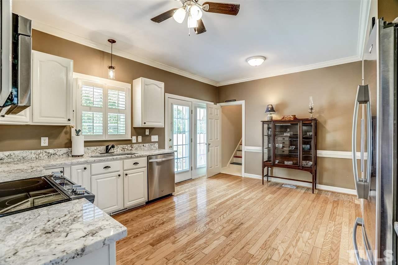 1004 Tyler Farms Drive Raleigh, NC 27603 - Photo 12 of 29 a kitchen with stainless steel appliances granite countertop a stove and a refrigerator