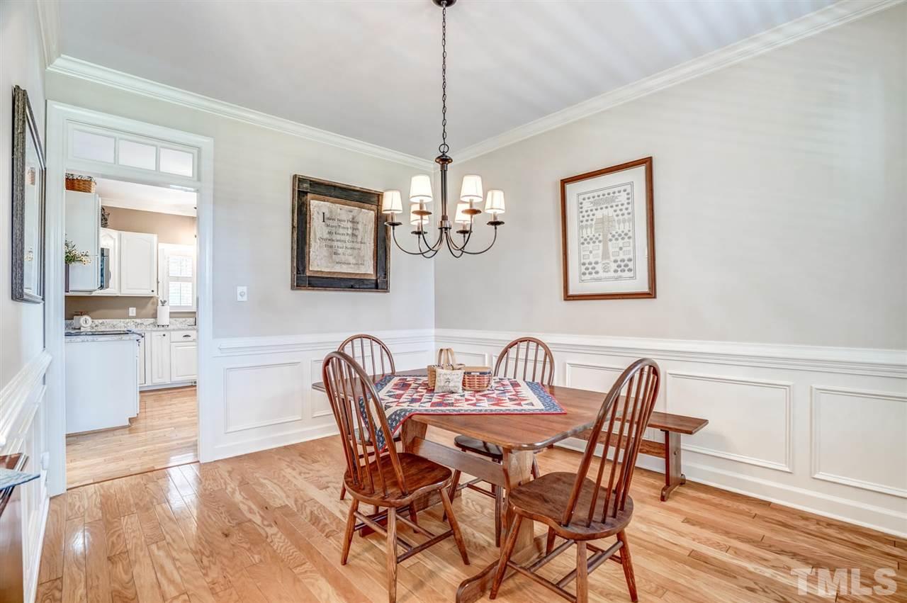 1004 Tyler Farms Drive Raleigh, NC 27603 - Photo 17 of 29 a view of a dining room with furniture wooden floor and a chandelier