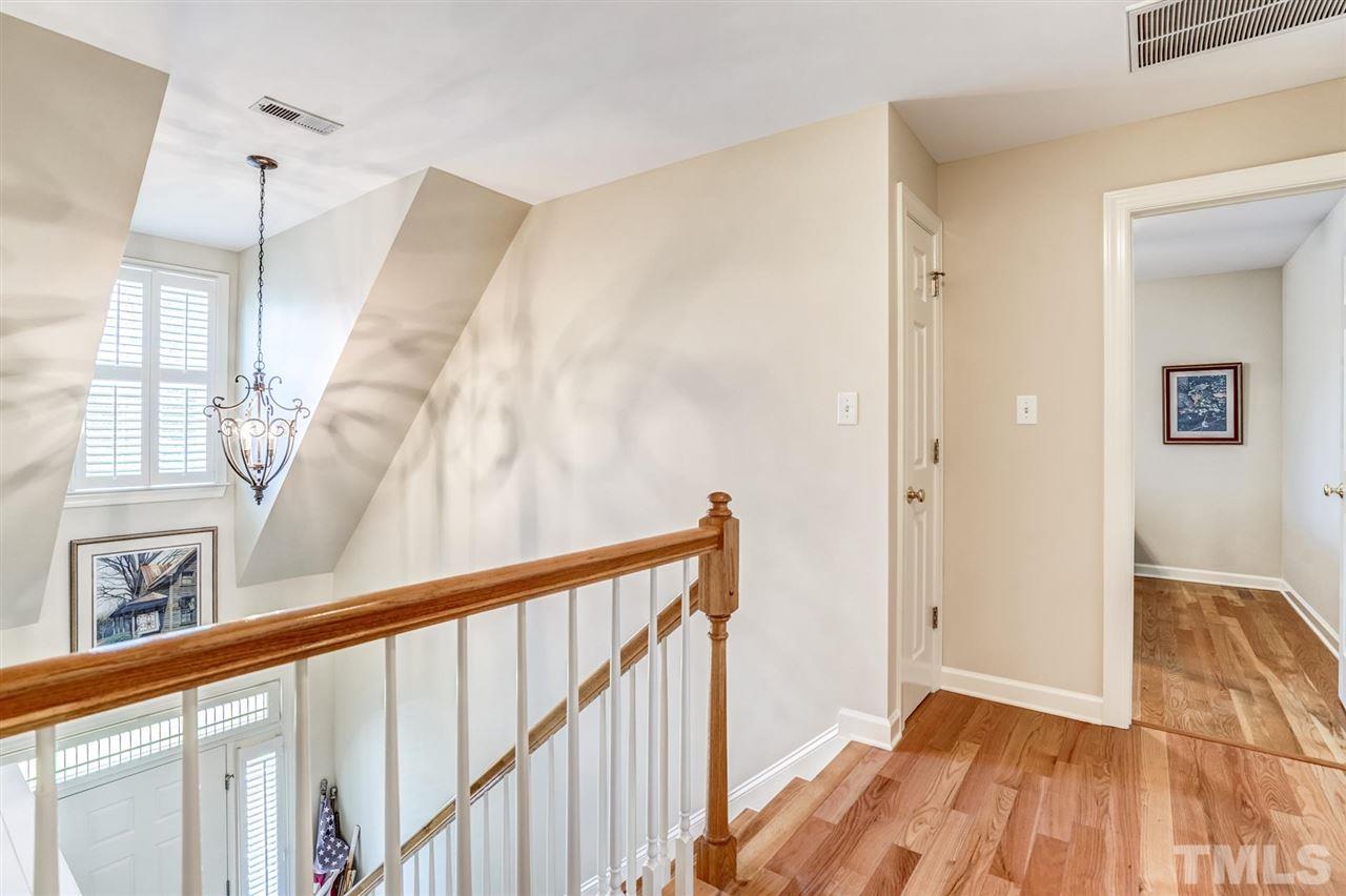 1004 Tyler Farms Drive Raleigh, NC 27603 - Photo 18 of 29 a view of a hallway with wooden floor and staircase