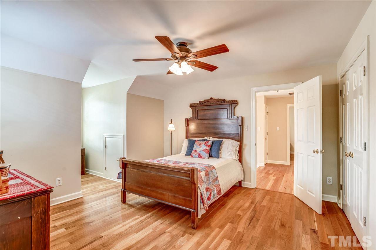 1004 Tyler Farms Drive Raleigh, NC 27603 - Photo 19 of 29 a bedroom with a bed and wooden floor