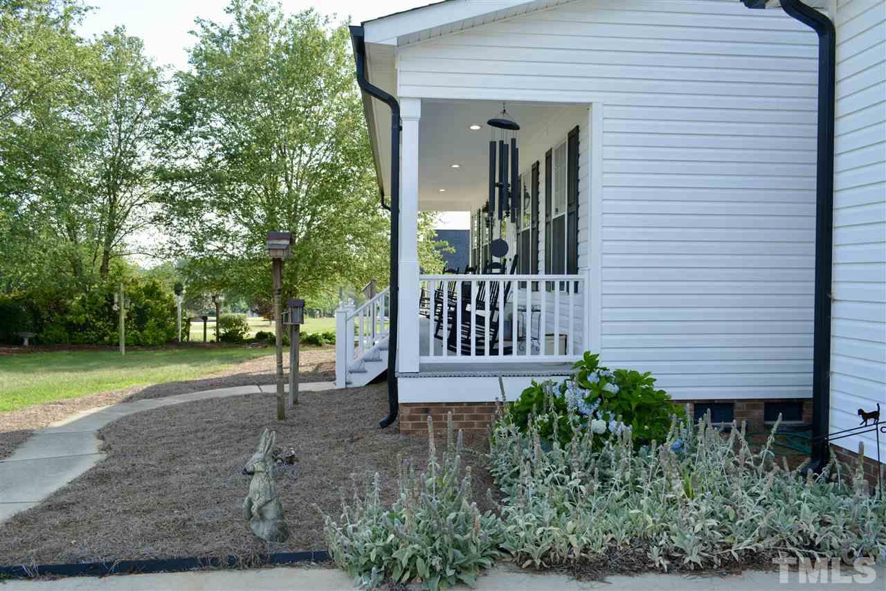 1004 Tyler Farms Drive Raleigh, NC 27603 - Photo 3 of 29 a view of a house with a yard and a garden