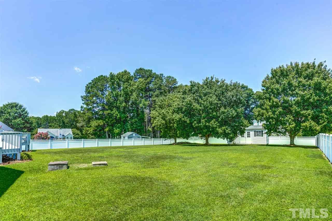 1004 Tyler Farms Drive Raleigh, NC 27603 - Photo 26 of 29 a view of grassy field with benches
